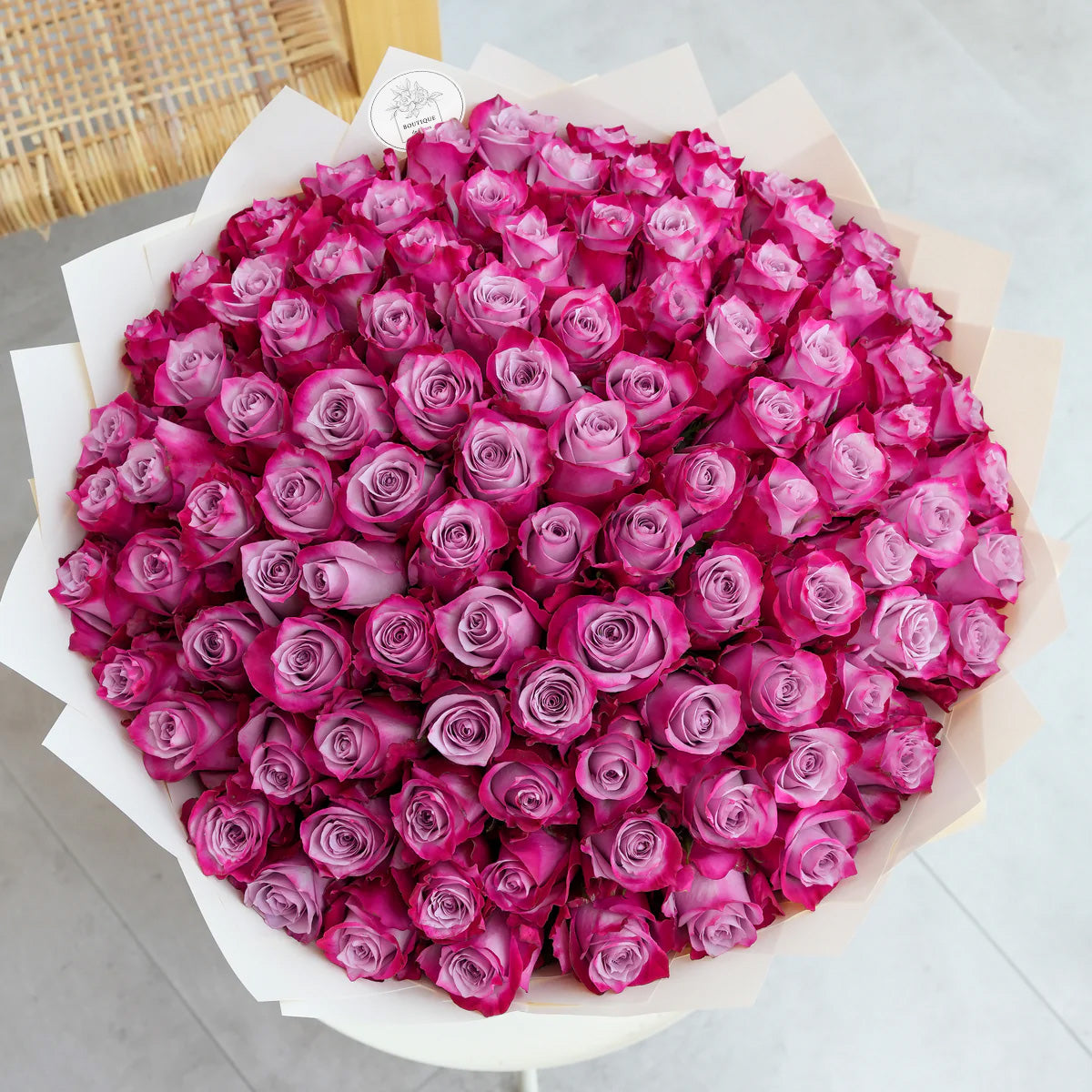 Bouquet of 100 fresh purple roses for luxury flower delivery in Lahore