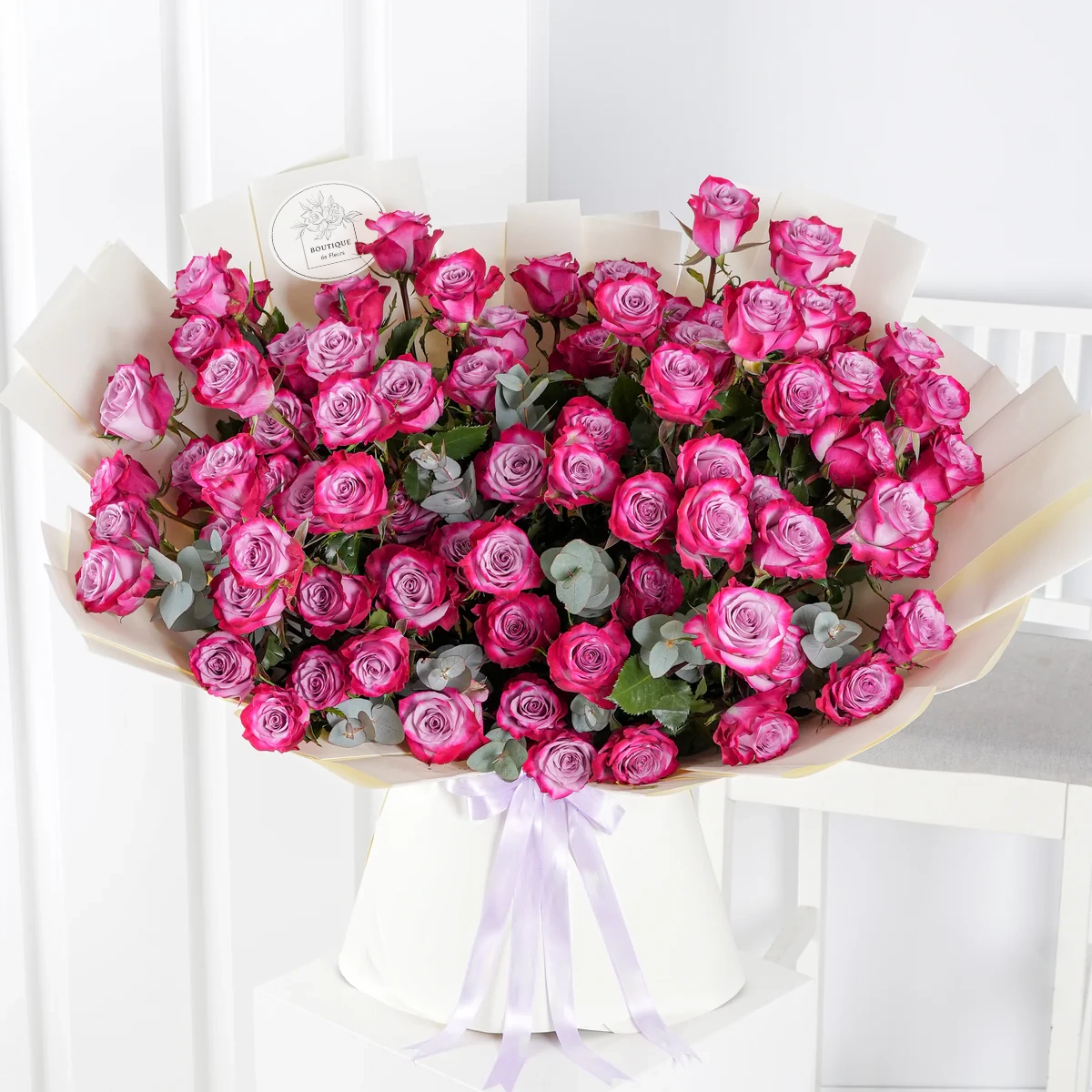 Bouquet of 100 fresh purple roses for luxury flower delivery in Lahore