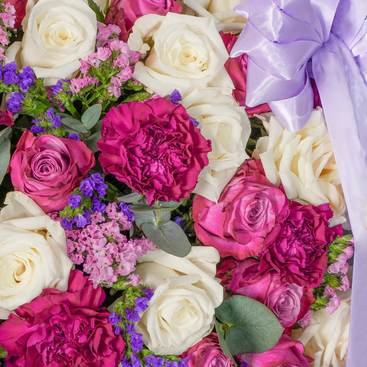 Amelia luxury hatbox with purple and white roses, purple carnations, and pink & purple statice, available for flower delivery in Lahore