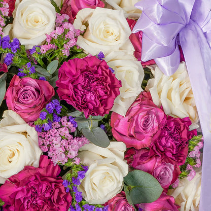 Amelia luxury hatbox with purple and white roses, purple carnations, and pink & purple statice, available for flower delivery in Lahore