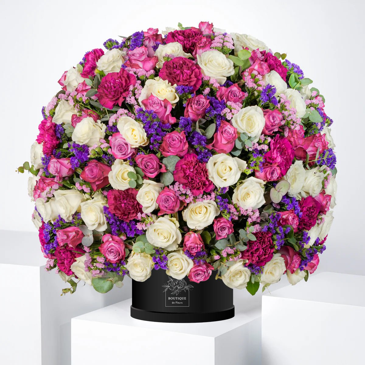 Amelia luxury hatbox with purple and white roses, purple carnations, and pink & purple statice, available for flower delivery in Lahore