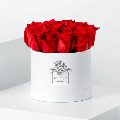 Crimson Amour luxury hatbox with fresh red roses, available for flower delivery in Lahore