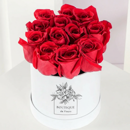 Crimson Amour luxury hatbox with fresh red roses, available for flower delivery in Lahore