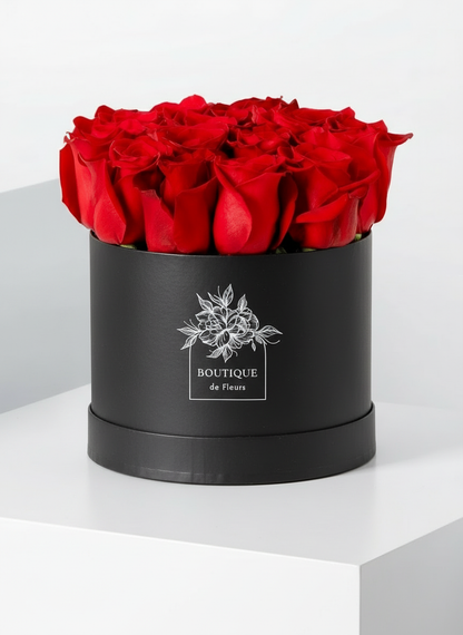 Crimson Amour luxury hatbox with fresh red roses, available for flower delivery in Lahore
