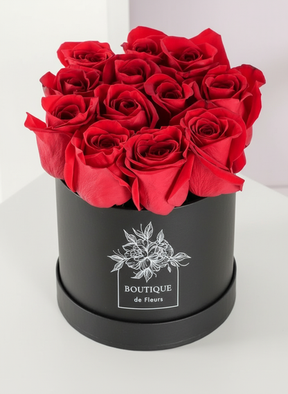 Crimson Amour luxury hatbox with fresh red roses, available for flower delivery in Lahore