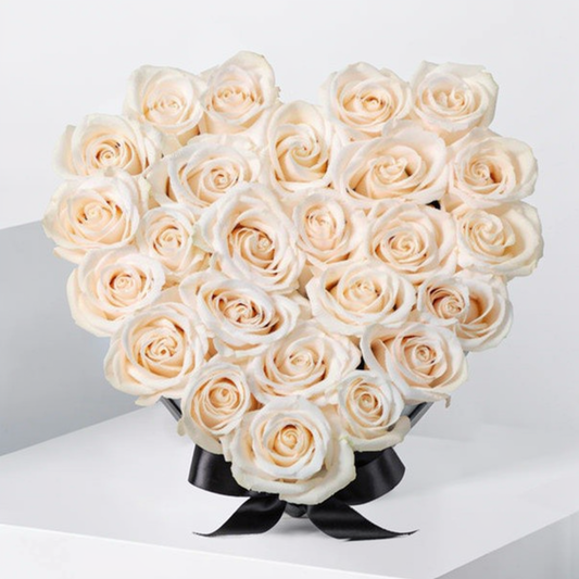 20-25 fresh white roses arranged in a heart-shaped box for Valentine’s Day delivery in Lahore